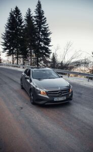 Mercedes vehicle driving on a mountain road for Interlaken private transfer service 