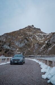 Luxury Mercedes driving on a scenic Swiss mountain road with private chauffeur Geneva